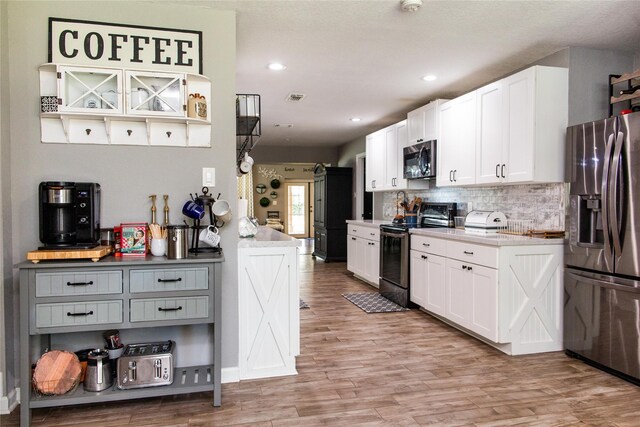 kitchen with gray cabinetry, light hardwood / wood-style floors, stainless steel appliances, and white cabinets