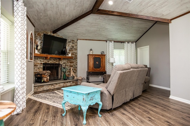 living room with hardwood / wood-style floors, vaulted ceiling with beams, a healthy amount of sunlight, and a stone fireplace