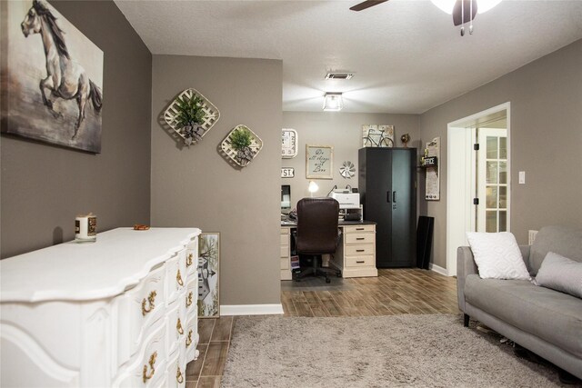 office with hardwood / wood-style floors, a textured ceiling, and ceiling fan