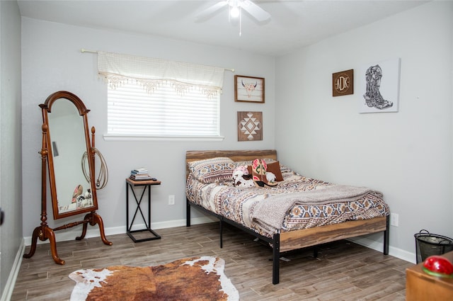 bedroom featuring hardwood / wood-style floors and ceiling fan