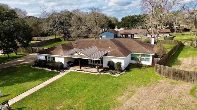 view of front of house with a front yard and a patio