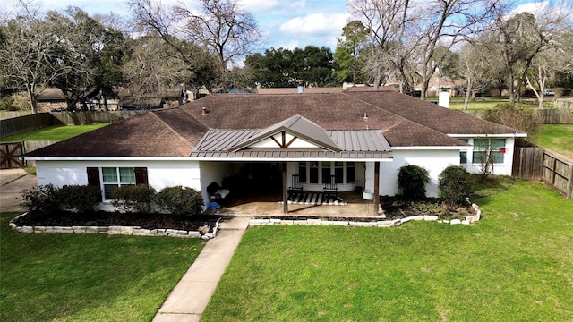 back of house with a patio area and a lawn