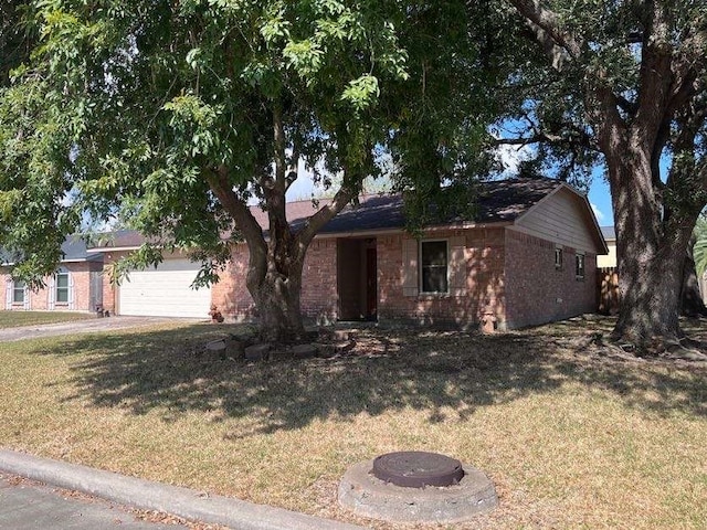 single story home with a front yard and a garage