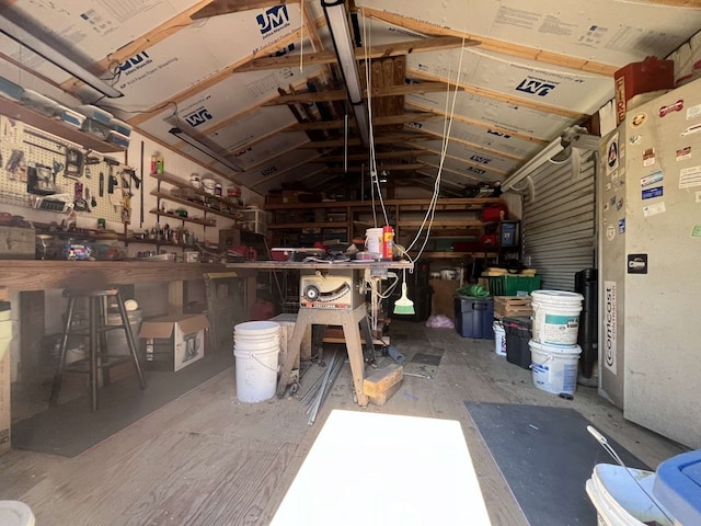 miscellaneous room with a workshop area and lofted ceiling