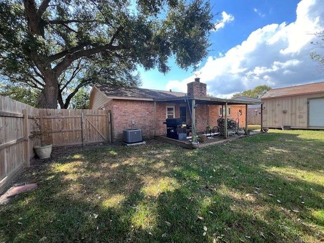 back of house featuring central air condition unit, a patio, and a lawn