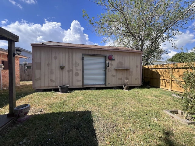 view of outbuilding with a yard