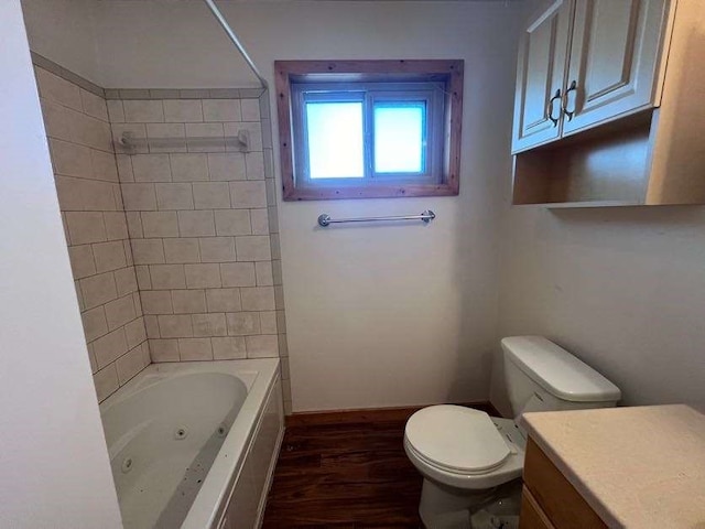 full bathroom with vanity, tiled shower / bath combo, wood-type flooring, and toilet