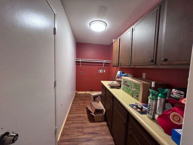 laundry area with dark hardwood / wood-style flooring