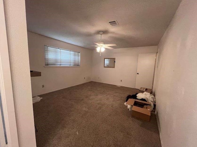 spare room with ceiling fan, carpet flooring, and a textured ceiling