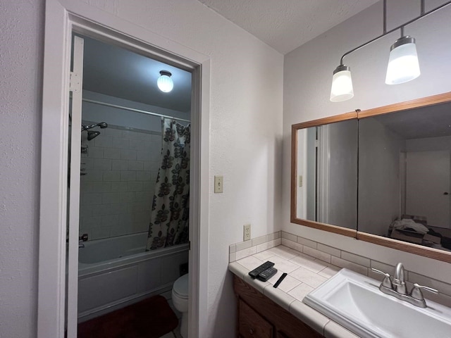 full bathroom featuring vanity, shower / bath combination with curtain, a textured ceiling, and toilet