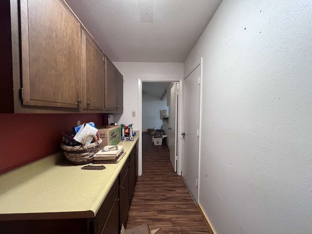 kitchen with dark wood-type flooring and a textured ceiling