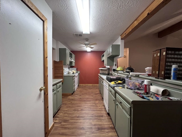 kitchen with hardwood / wood-style floors, beam ceiling, ceiling fan, a textured ceiling, and white appliances