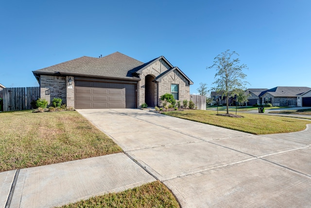 view of front of house featuring a front lawn and a garage