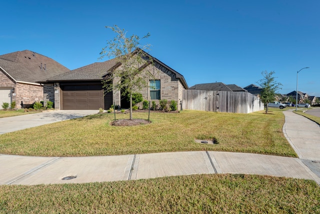 view of front of home featuring a front yard and a garage