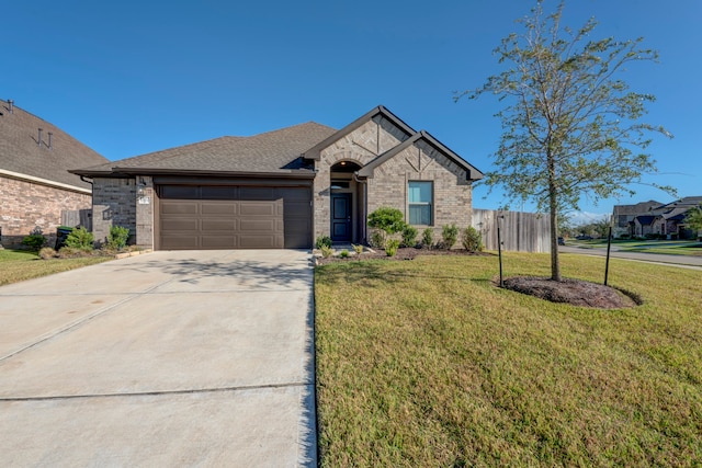 view of front of home with a front yard and a garage