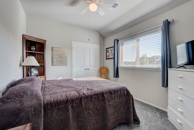 bedroom with lofted ceiling, carpet, a closet, and ceiling fan