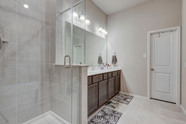 bathroom with vanity, an enclosed shower, and tile patterned floors