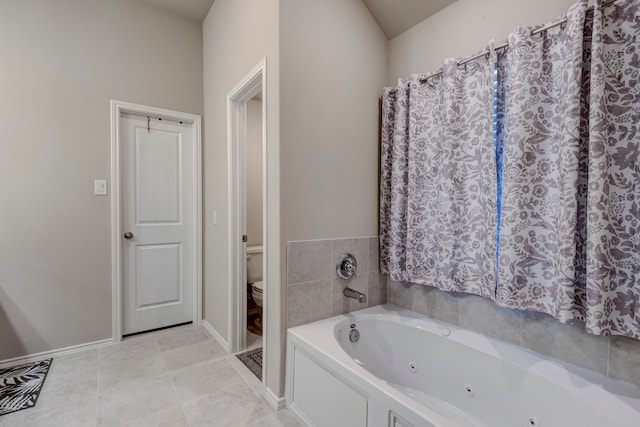 bathroom with toilet, tile patterned floors, and a bathing tub