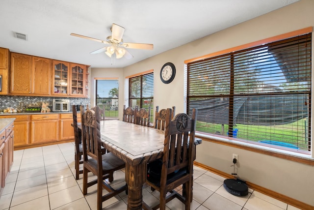 tiled dining room with ceiling fan