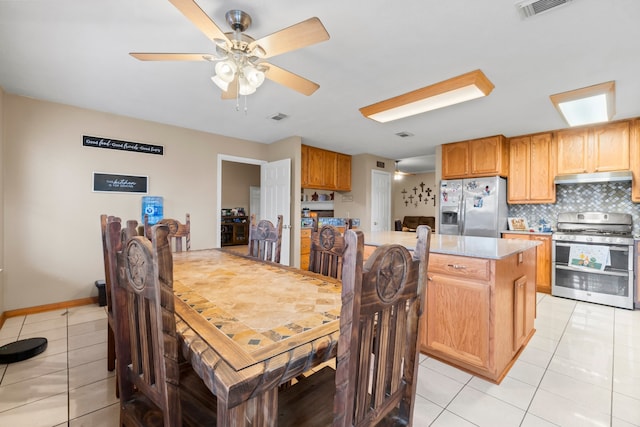 dining space featuring light tile patterned flooring and ceiling fan