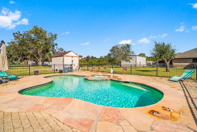 view of swimming pool with a patio, an in ground hot tub, and a yard