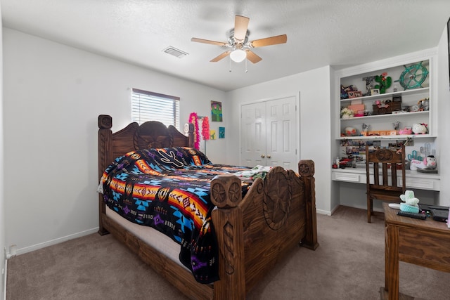 carpeted bedroom featuring a closet, ceiling fan, and a textured ceiling