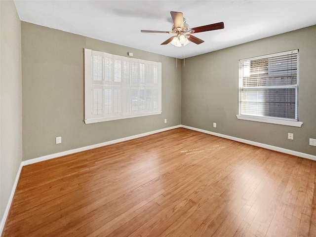 unfurnished room with ceiling fan and hardwood / wood-style flooring