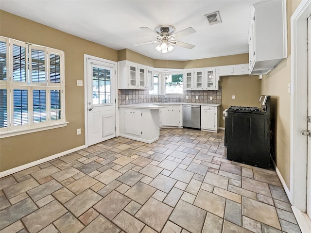 kitchen featuring ceiling fan, backsplash, white cabinetry, stainless steel dishwasher, and black range oven