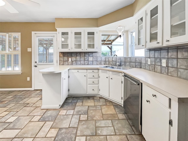 kitchen featuring sink, tasteful backsplash, stainless steel dishwasher, white cabinets, and ceiling fan