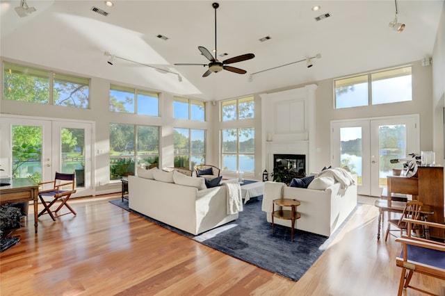 living room featuring french doors and a towering ceiling