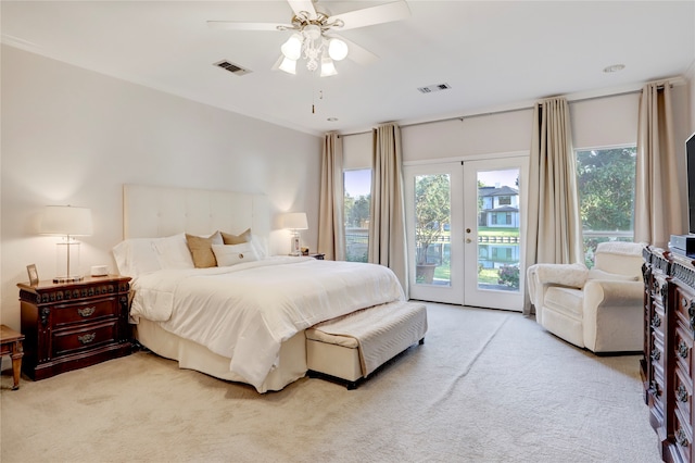 carpeted bedroom featuring french doors, ceiling fan, and access to exterior