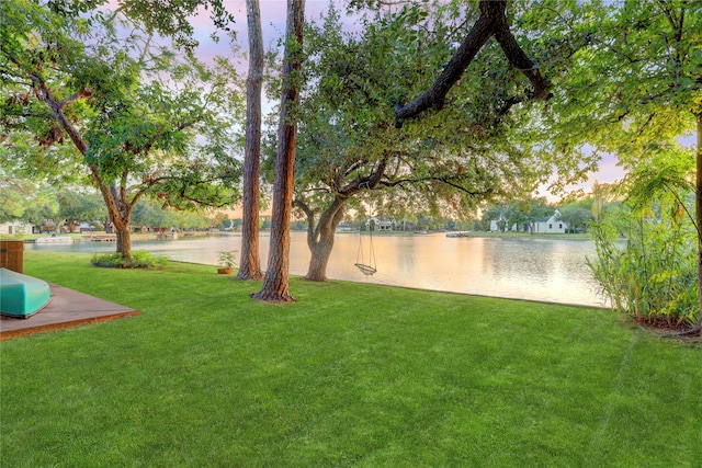 yard at dusk with a water view