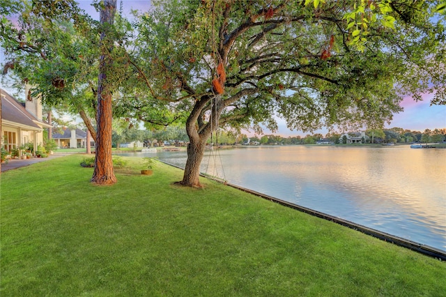 yard at dusk with a water view