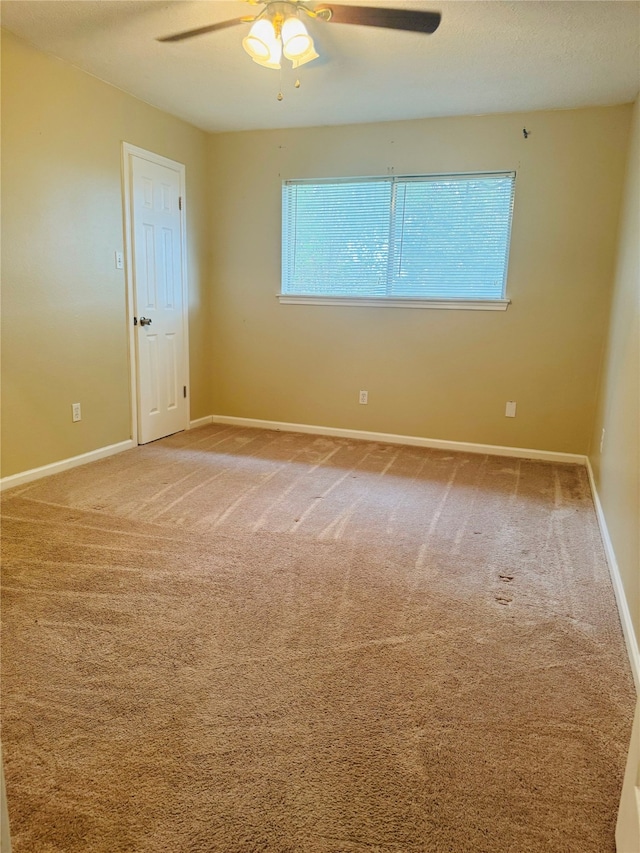 carpeted empty room with ceiling fan