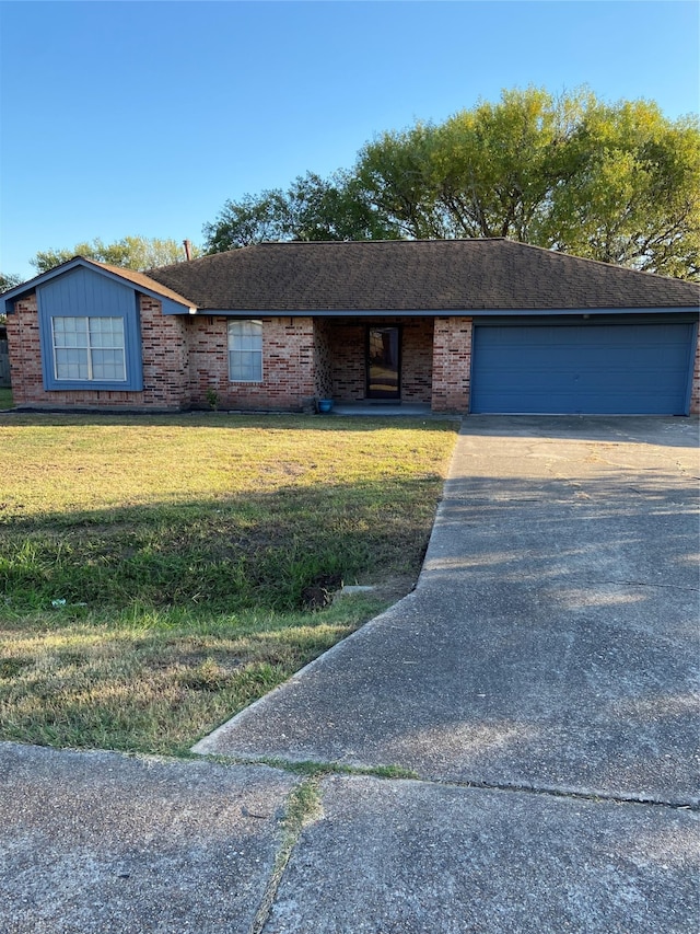 ranch-style home with a front yard and a garage