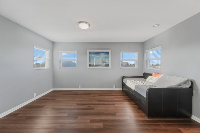 bedroom with dark hardwood / wood-style floors