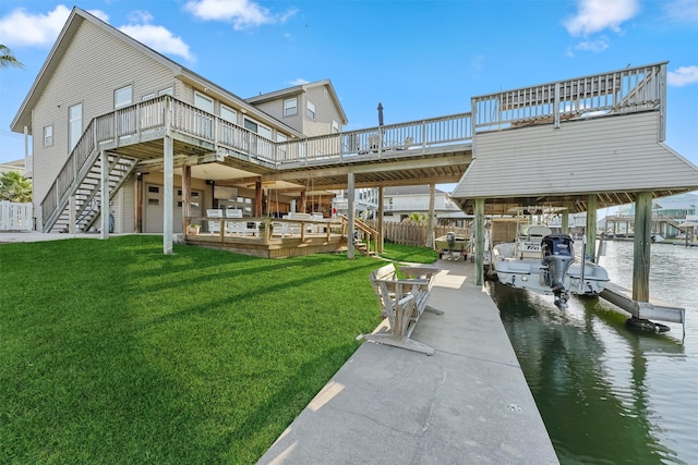 dock area featuring a deck with water view and a yard