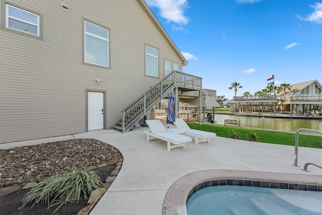 view of pool featuring a patio and a water view