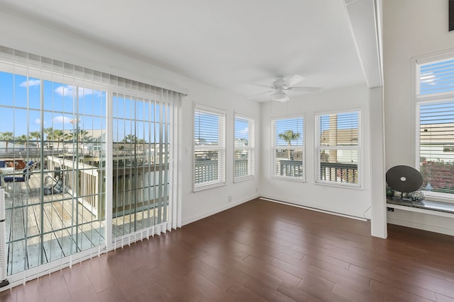 unfurnished sunroom featuring ceiling fan