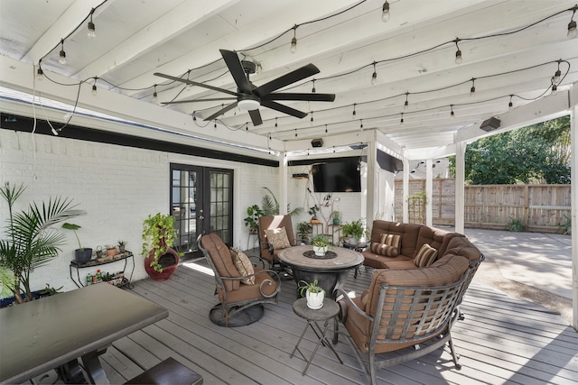 wooden terrace featuring french doors, outdoor lounge area, and ceiling fan