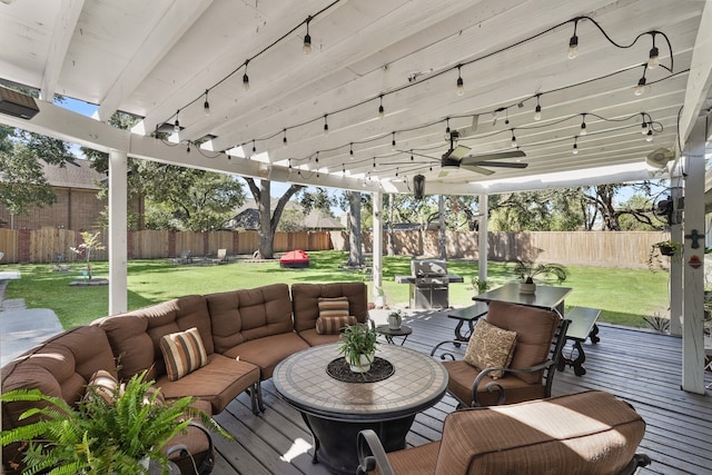 deck featuring an outdoor living space, area for grilling, and a yard