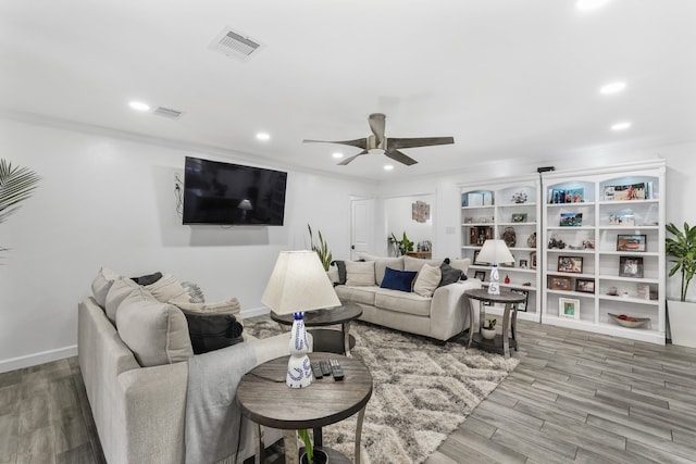 living room with ceiling fan, crown molding, and wood-type flooring