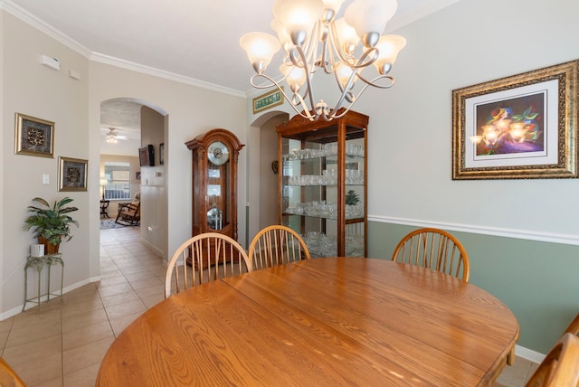 dining space featuring ceiling fan, crown molding, and light tile patterned floors