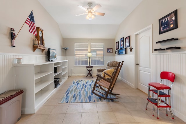 sitting room with ceiling fan, light tile patterned flooring, and vaulted ceiling