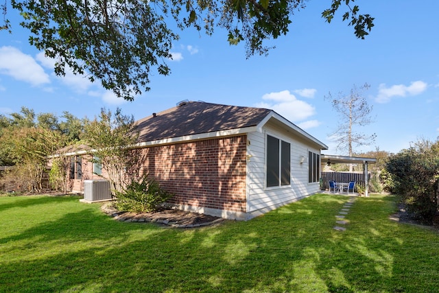 view of home's exterior with a yard and central AC unit