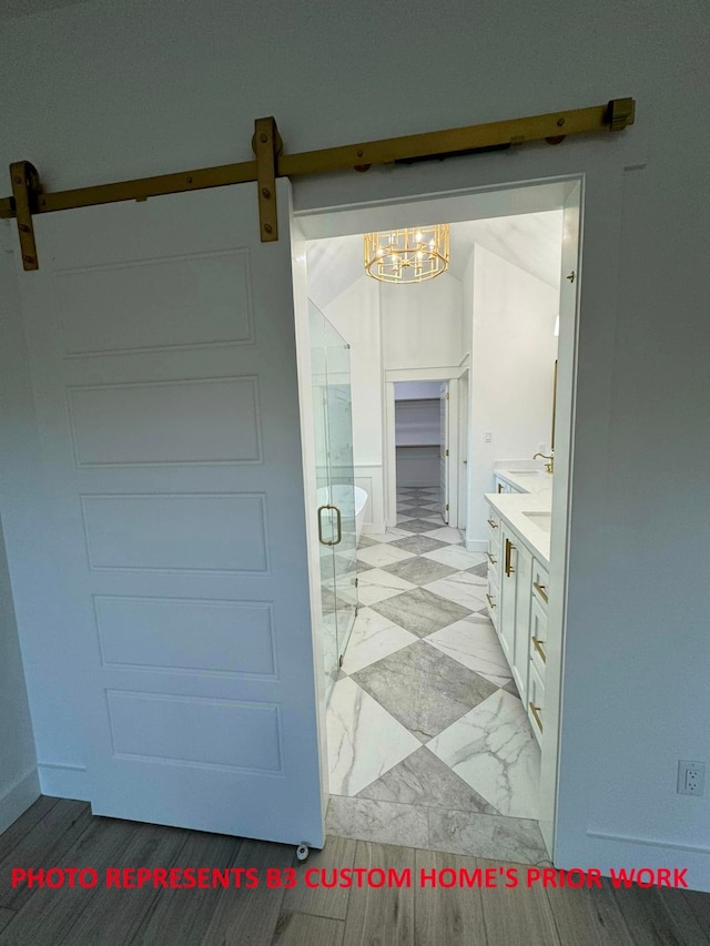 bathroom featuring vanity, an inviting chandelier, and walk in shower