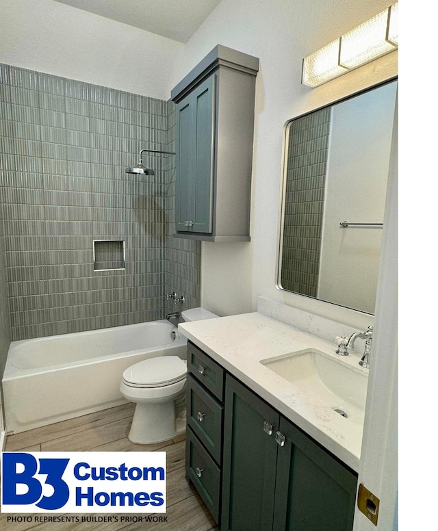 full bathroom with toilet, tiled shower / bath combo, and vanity