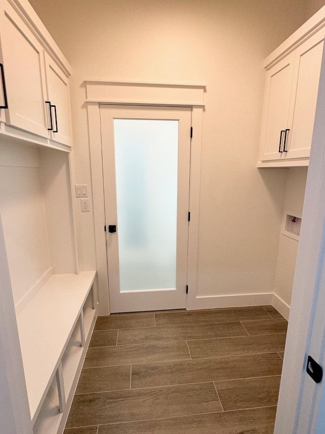 mudroom featuring wood tiled floor and baseboards