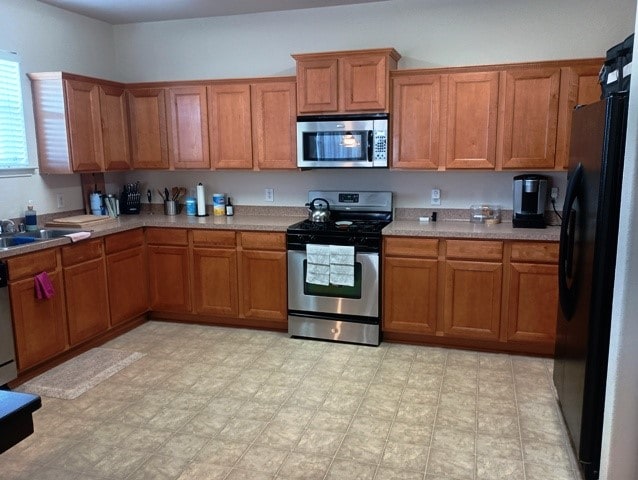 kitchen with sink and appliances with stainless steel finishes