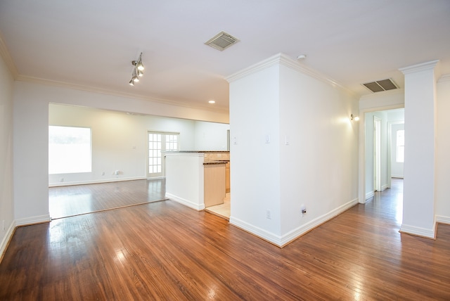 empty room featuring crown molding and hardwood / wood-style flooring